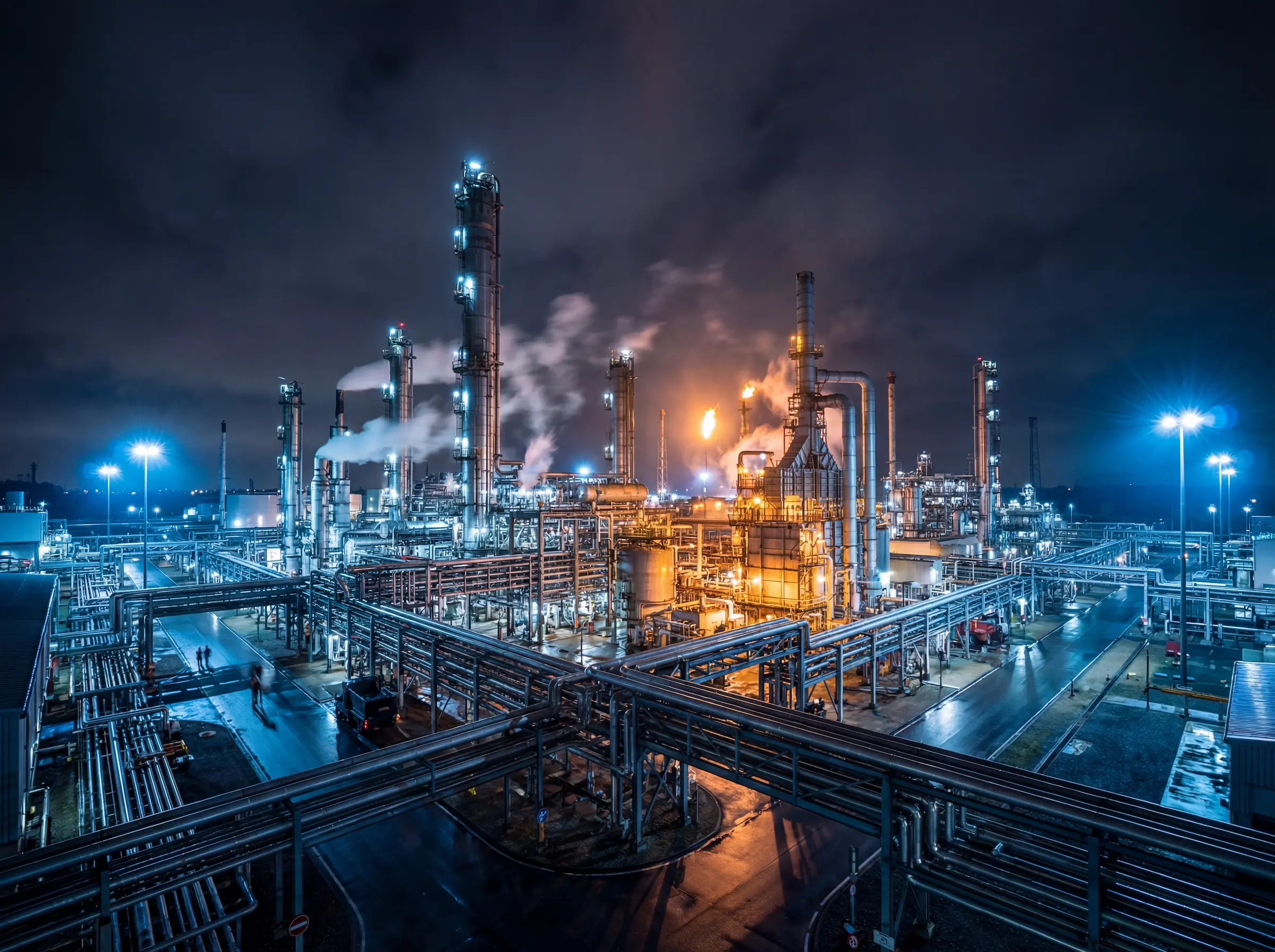 AI-generated industrial oil and gas refinery plant with pipelines, distillation towers and processing units in a large-scale energy facility